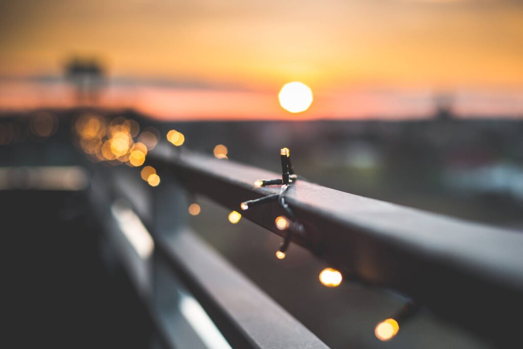 Christmas Lights Bokeh Against Sunset Free Photo