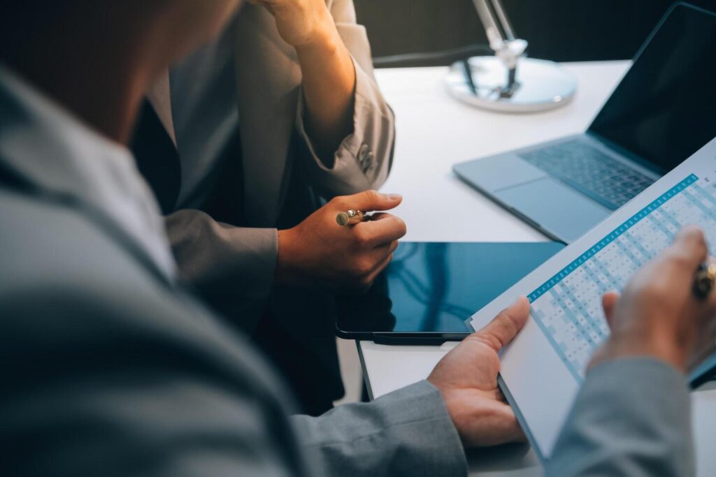 Close up of Business team analyzing income charts and graphs with modern laptop computer. Business analysis and strategy concept. Stock Free