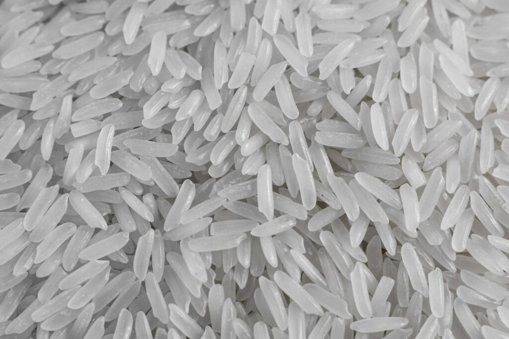 Close up of dry raw white rice background. Macro top view of uncooked grain. Traditional food meal or ingredient of asian culture. Stock Free