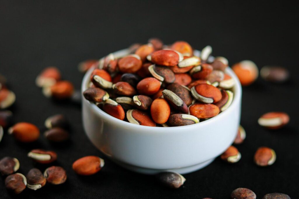 Close-up of kidney beans in a bowl on a black background. Stock Free