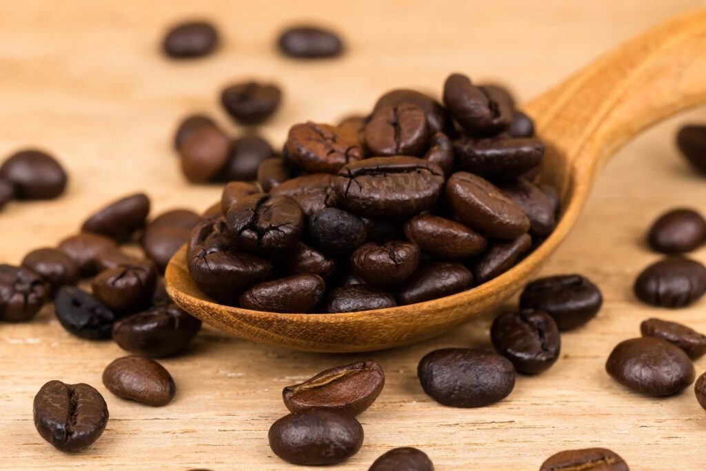 Coffee bean in wooden spoon Stock Free