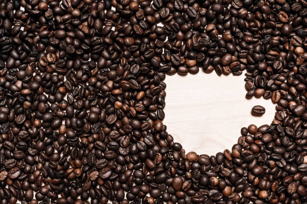 Coffee Cup Shape in Coffee Beans Free Photo