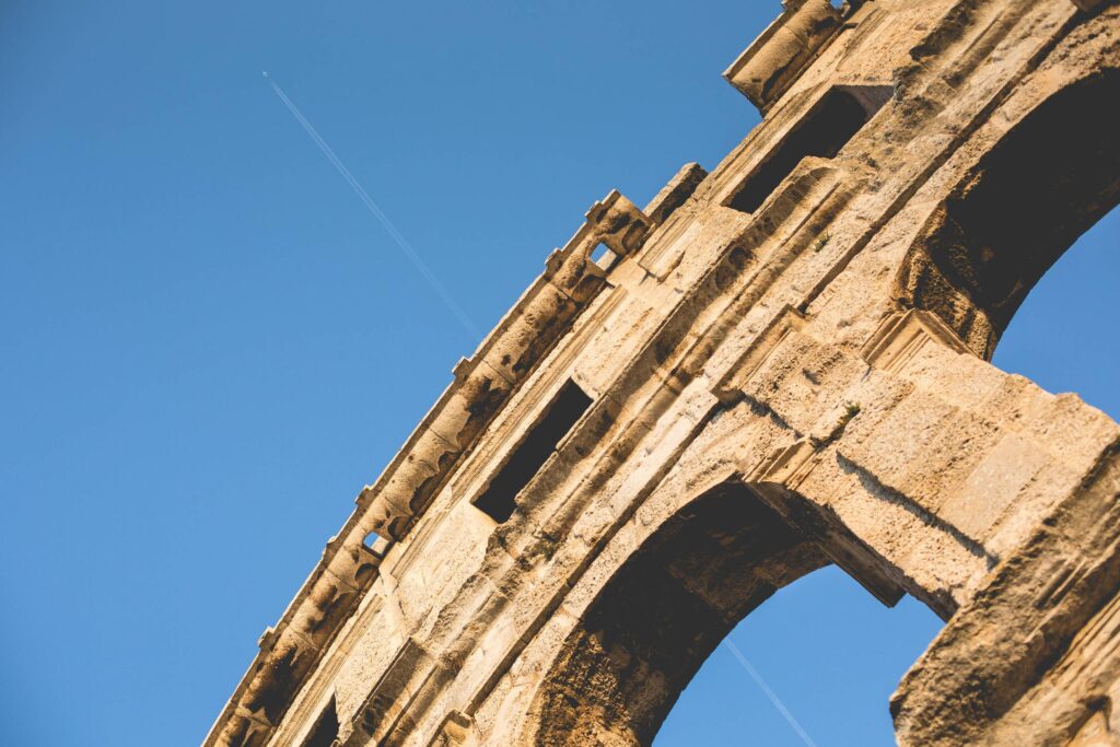 Coliseum in Pula with Plane Free Photo