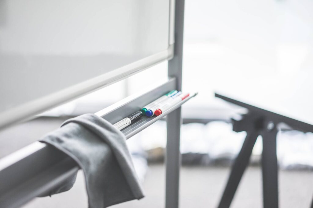 Colored Whiteboard Markers on Whiteboard Marker Tray in Office Free Photo