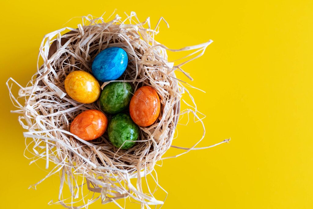 Colorful Easter Eggs on Yellow Background Free Photo