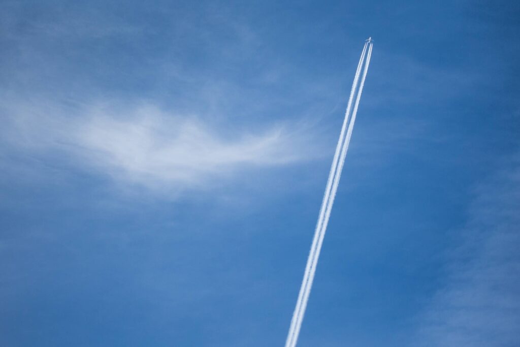 Contrails from Big Four-Engine Airplane Free Photo