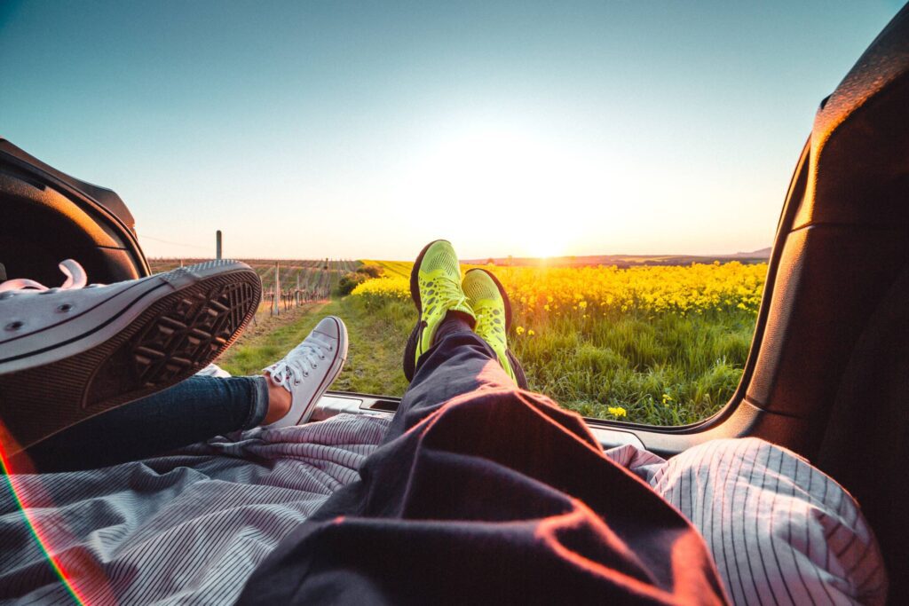 Couple Enjoying Sunset from the Car Trunk Free Photo