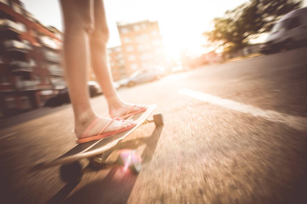 Crazy Girl Riding Her Longboard in Flip Flops Free Photo