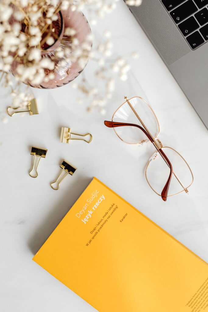 Creative Flatlay Design Book and Eyeglasses on the Table Free Photo