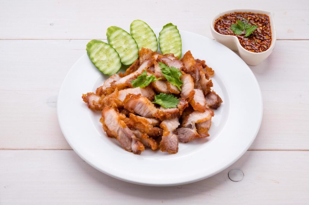 Crispy pork cutlets, ready to eat with fresh vegetables and spicy dipping sauce Stock Free