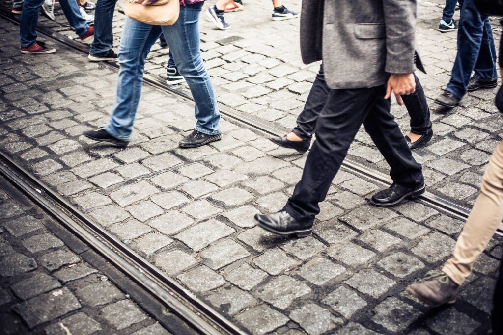 Crowd of People Crossing an Old Prague Road Free Photo