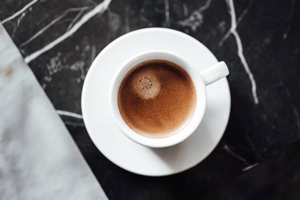 Cup of Strong Coffee on a Black Marble Table Free Photo