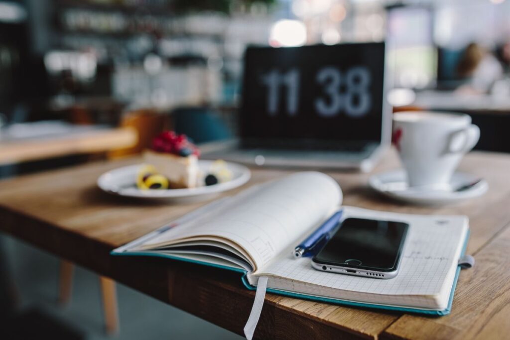 Working in a restaurant: Macbook, Cheese Cake and Cup of Coffee Stock Free