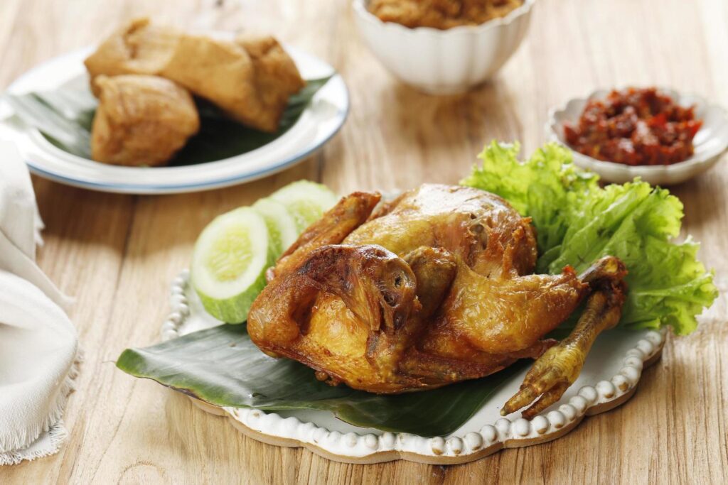 Deep Fried Whole Fried Chicken, Served with Cucumber, vegetable, and Sambal. Stock Free