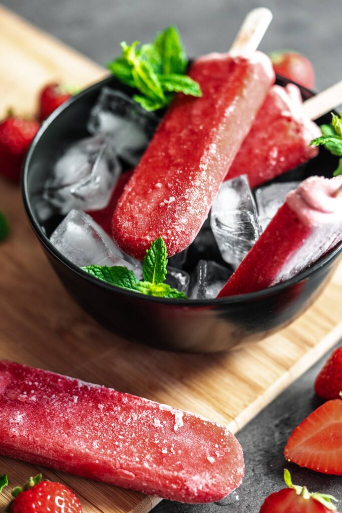 Delicious Strawberry Popsicles on a Wooden Board Free Photo