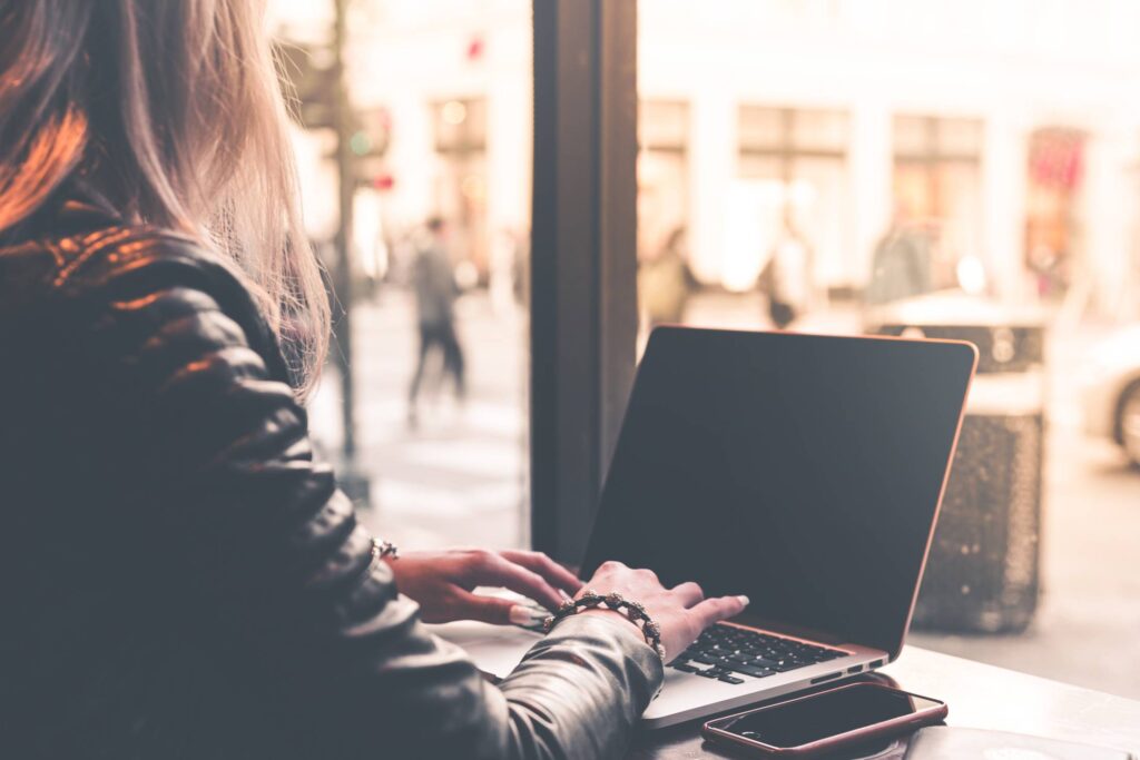 Digital Nomad Millenial Woman Working Remotely from Café Free Photo