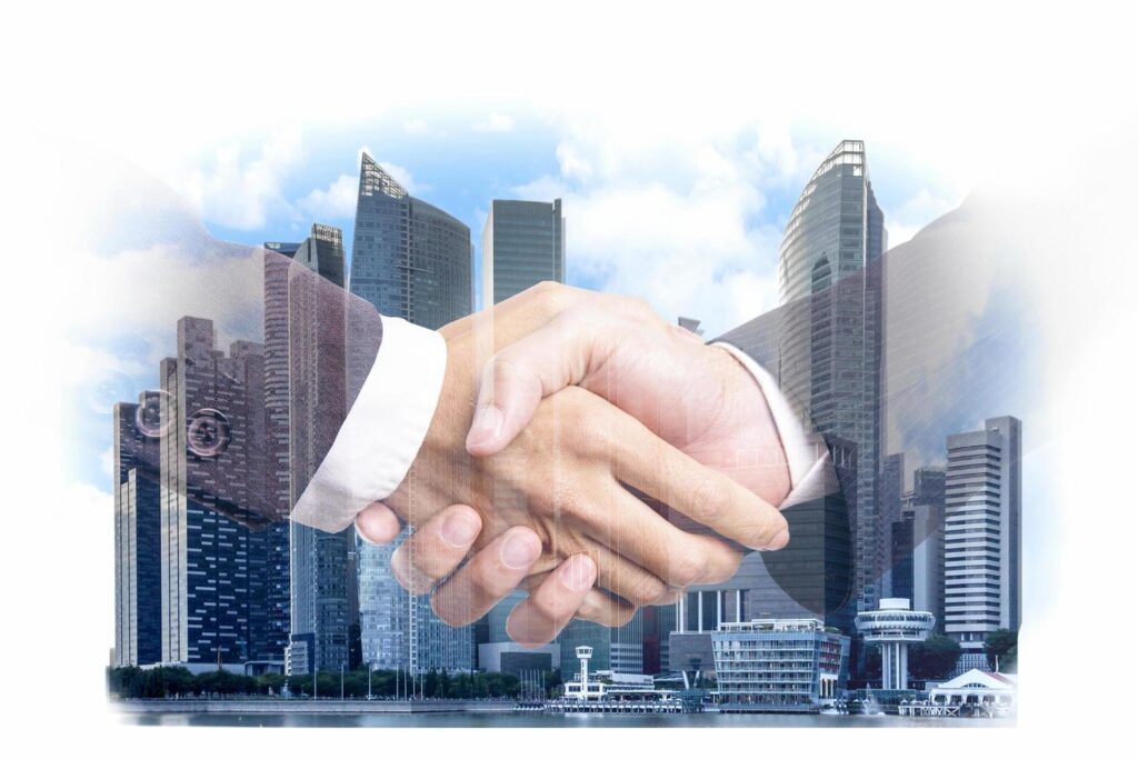 Double exposure of businessmen handshake on a modern city building financial district and commerce, business partnership successful and strategic plan concept Stock Free