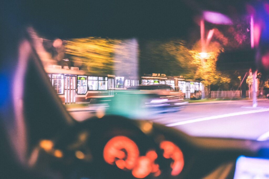 Driver Racing Against City Tram at Night Free Photo