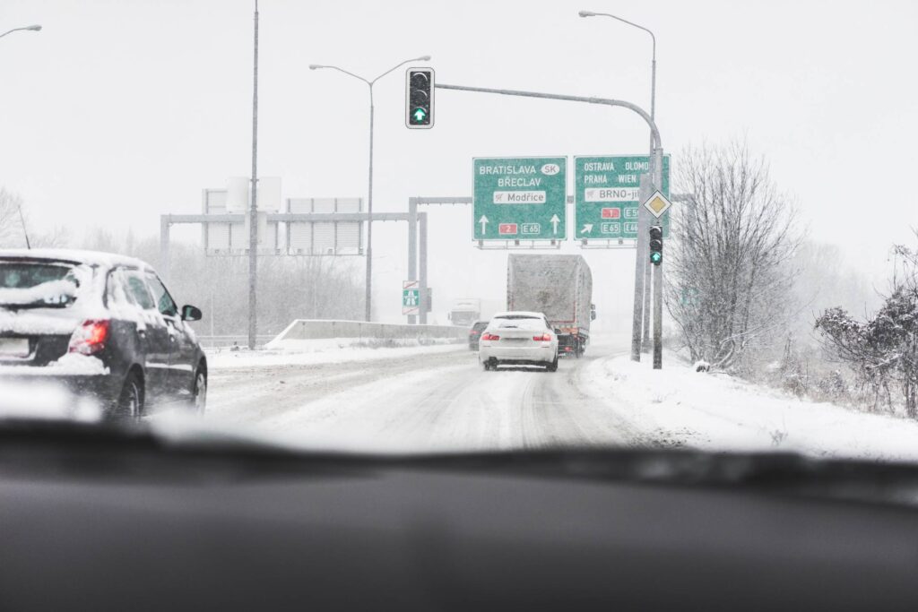 Driving in a Dangerous Snowy Weather on a Highway Free Photo