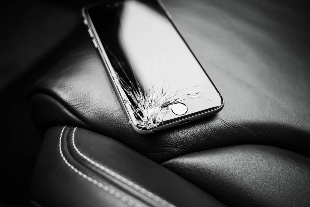 Dropped iPhone 6 with Cracked Screen on Car Seat Free Photo