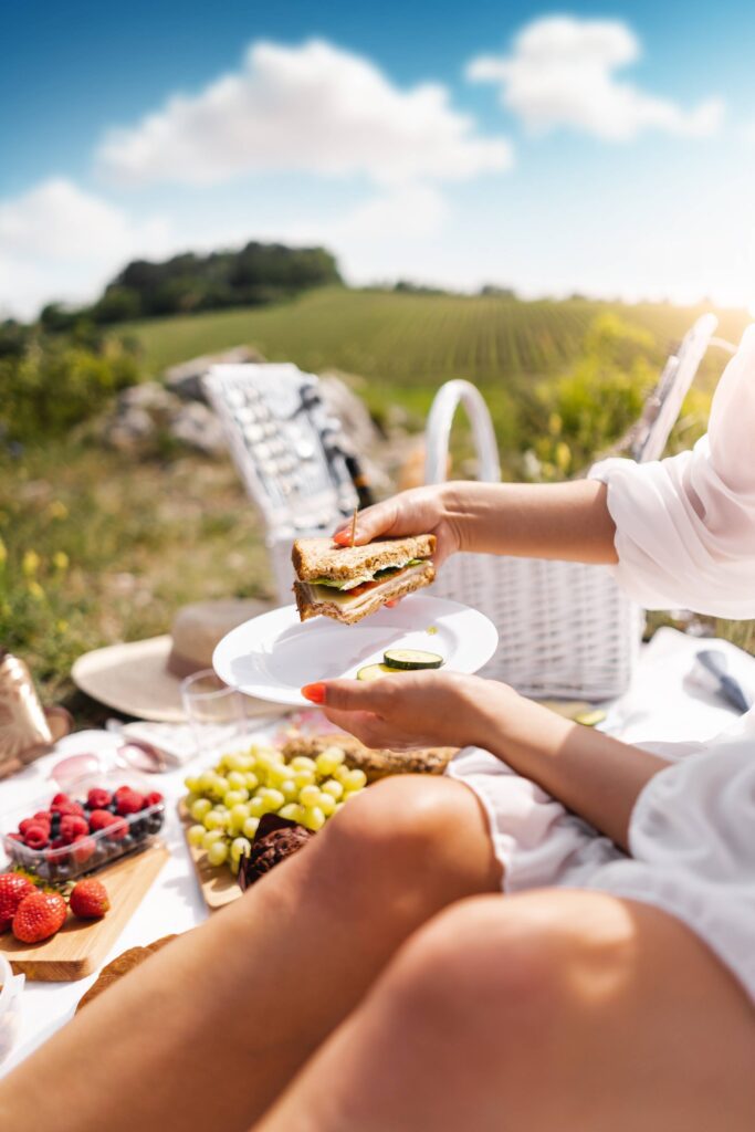 Eating a Sandwich on a Picnic Date Free Photo