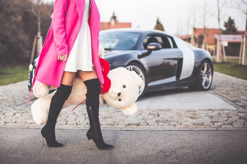 Elegant Woman Holding Big Teddy Bear with Red Heart Free Photo