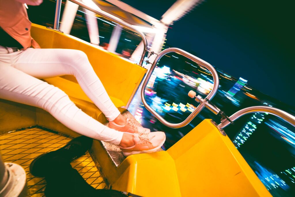 Enjoying Crazy Ferris Wheel in Amusement Park at Night Free Photo