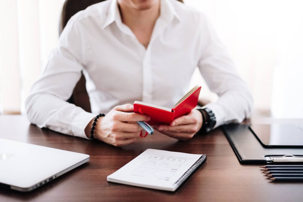 Entrepreneur Reading Notes in His Notebook Free Photo