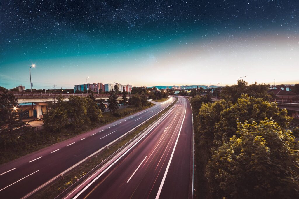 Evening Traffic in the City with Star Sky Free Photo