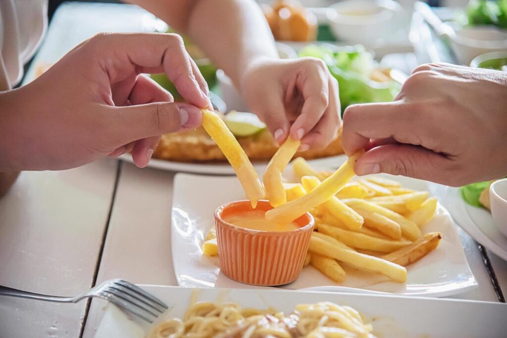 Family time eat French fries together – family life with food concept Stock Free