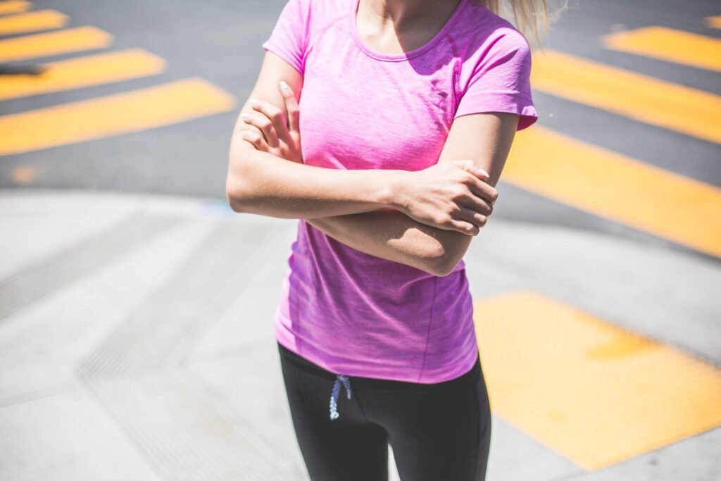 Fitness Girl Waiting At a Street Corner Near The Pedestrian Crossing Free Photo