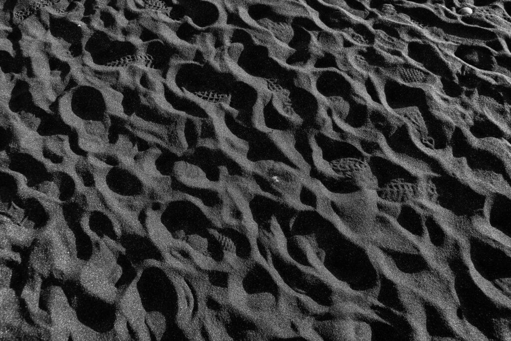 Footprints in The Black Sand Free Photo