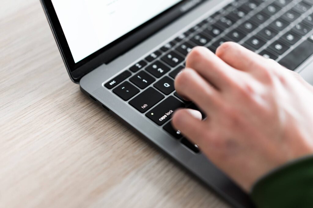 Freelance Man Typing on His Laptop Close Up Free Photo