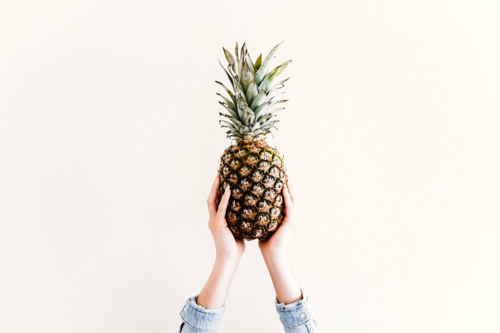 Fresh Ananas/Pineapple in Female Hands Free Photo