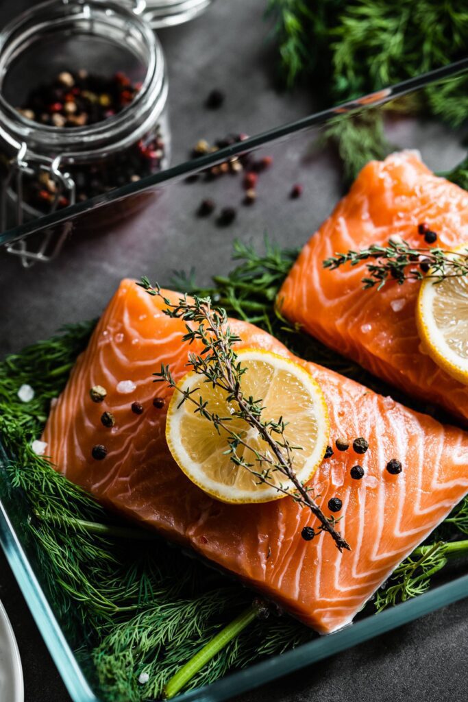 Fresh Raw Salmon Fillets with Aromatic Herbs Free Photo