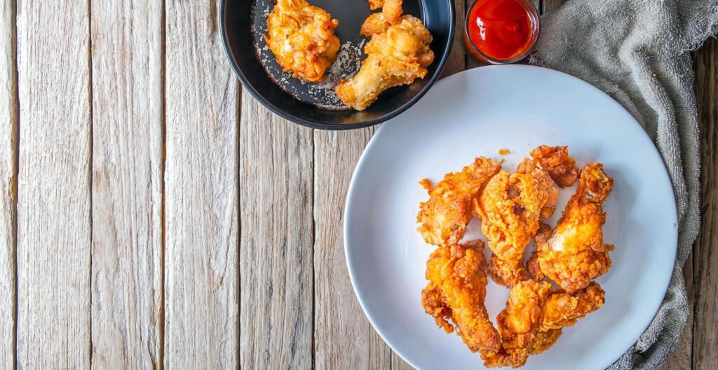 Fried chicken food and french fries on a wooden table Stock Free