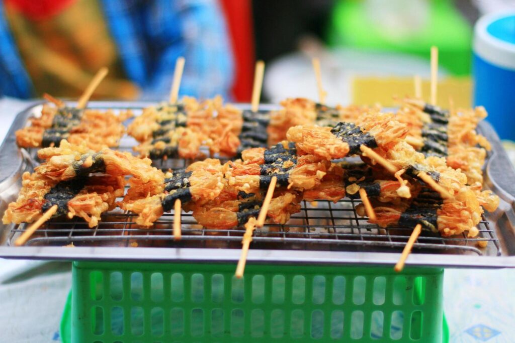 Fried Golden Needle Mushroom Skewers in street food at Thailand Stock Free