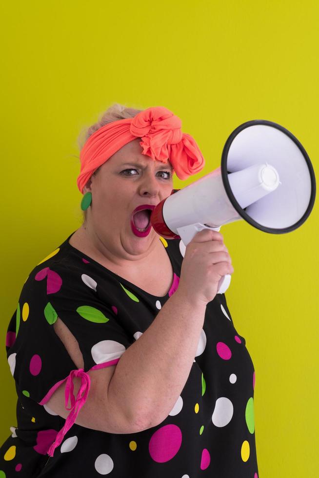 Funny plus size woman woman posing isolated on pastel green background studio portrait. People emotions lifestyle concept. Mock up copy space. Screaming in megaphone. Stock Free