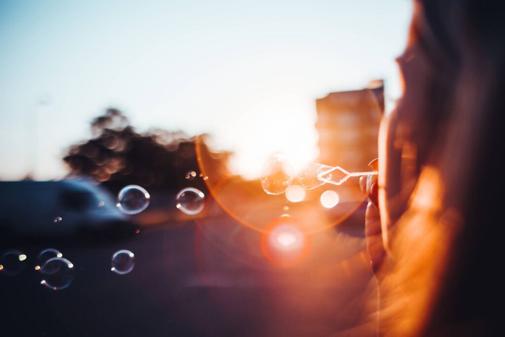 Girl Blowing Bubbles in the Sunset Evening Free Photo