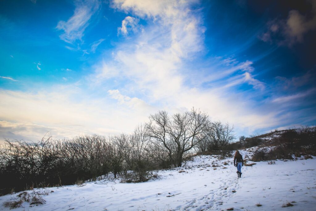 Girl Hiking on Snowy Hill Free Photo