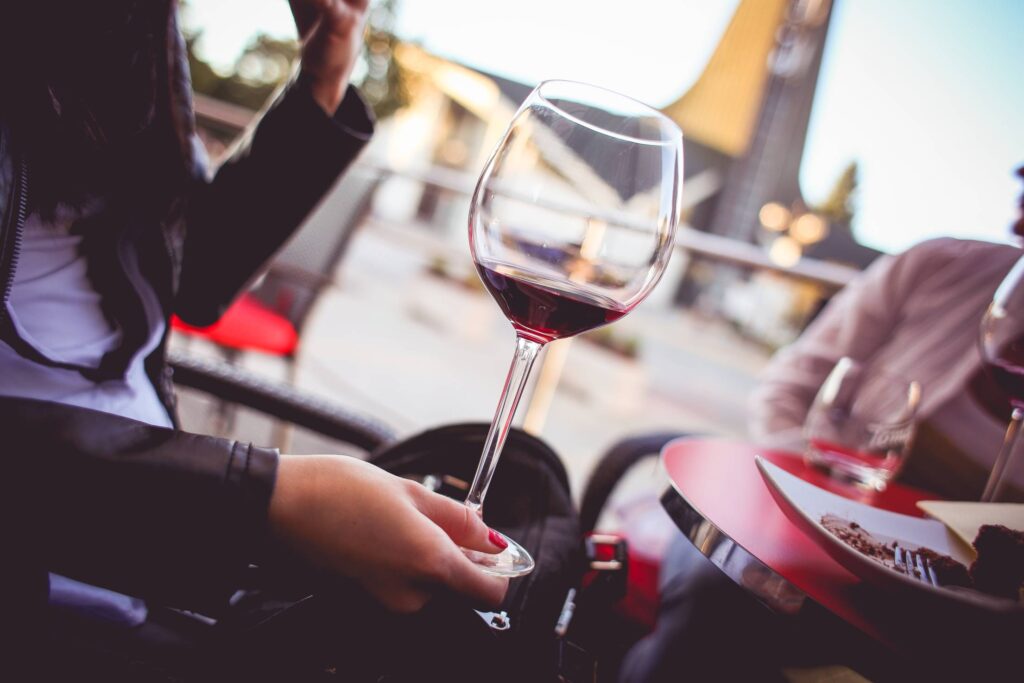 Girl Holding a Glass with Red Wine Free Photo