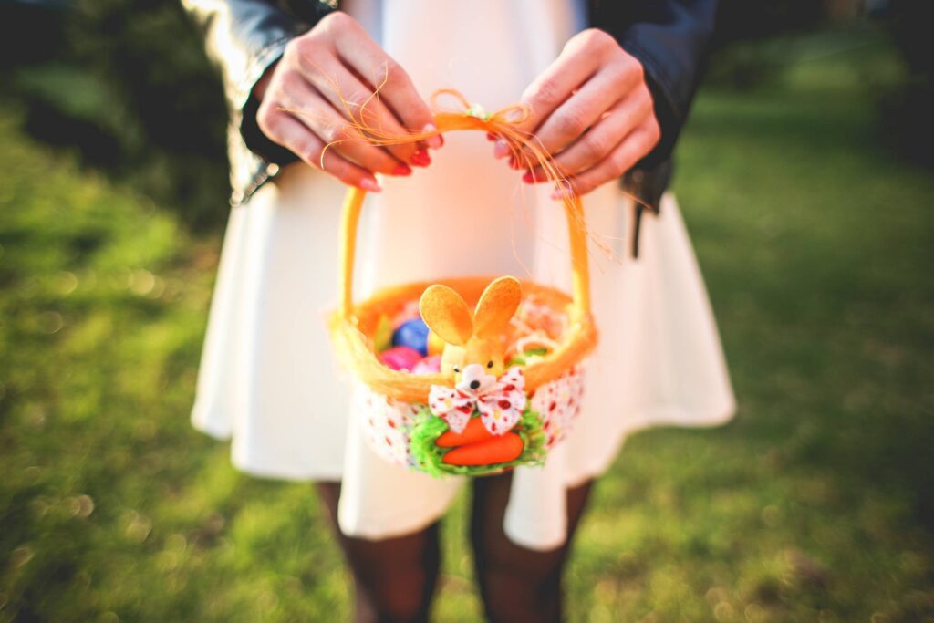 Girl Holding Basket with Colored Easter Eggs Free Photo