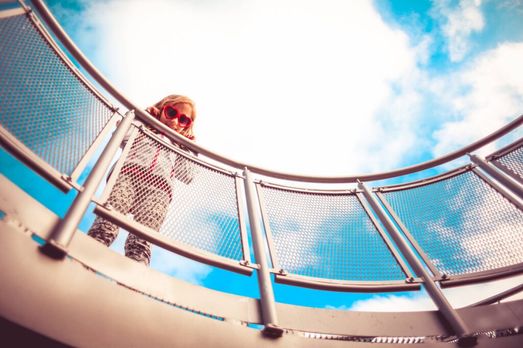 Girl Holding Onto The Railing Free Photo