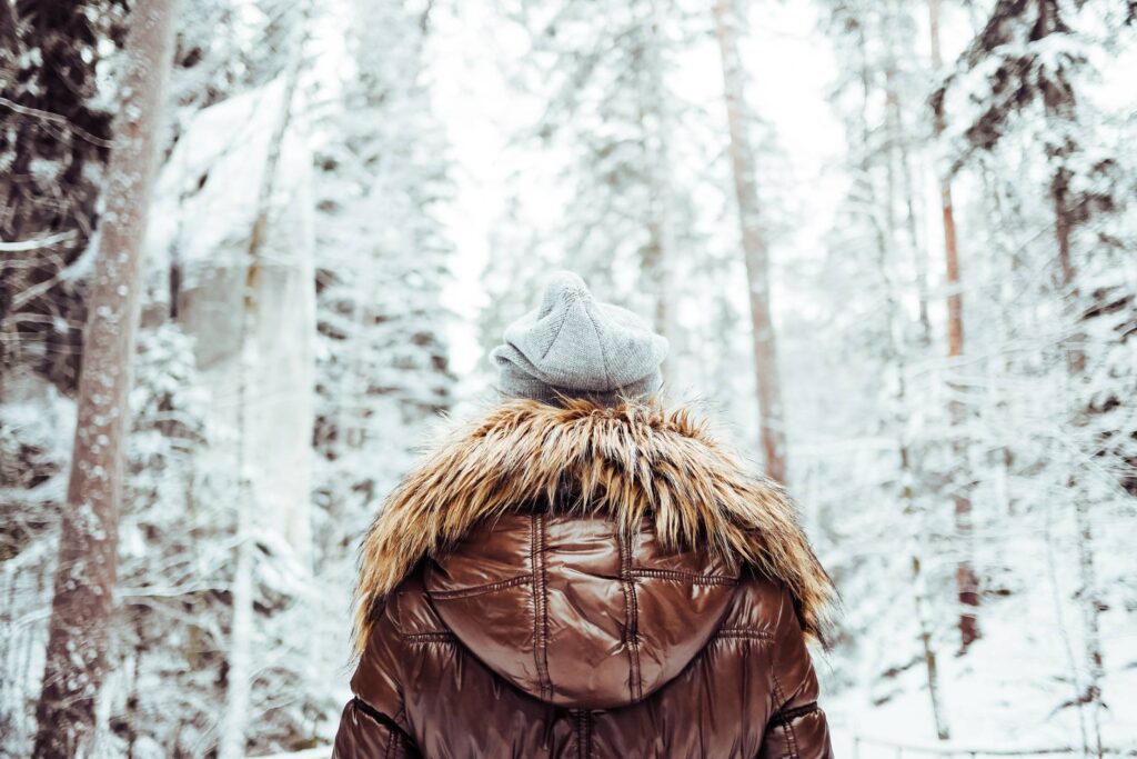 Girl in Winter Jacket Walking in Snowy Forest Free Photo