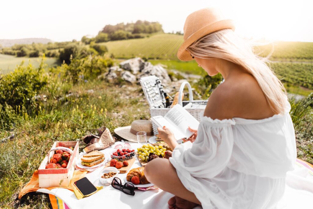 Girl Reading at a Picnic Free Photo