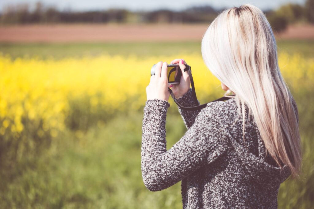 Girl Taking a Photo in Nature Free Photo