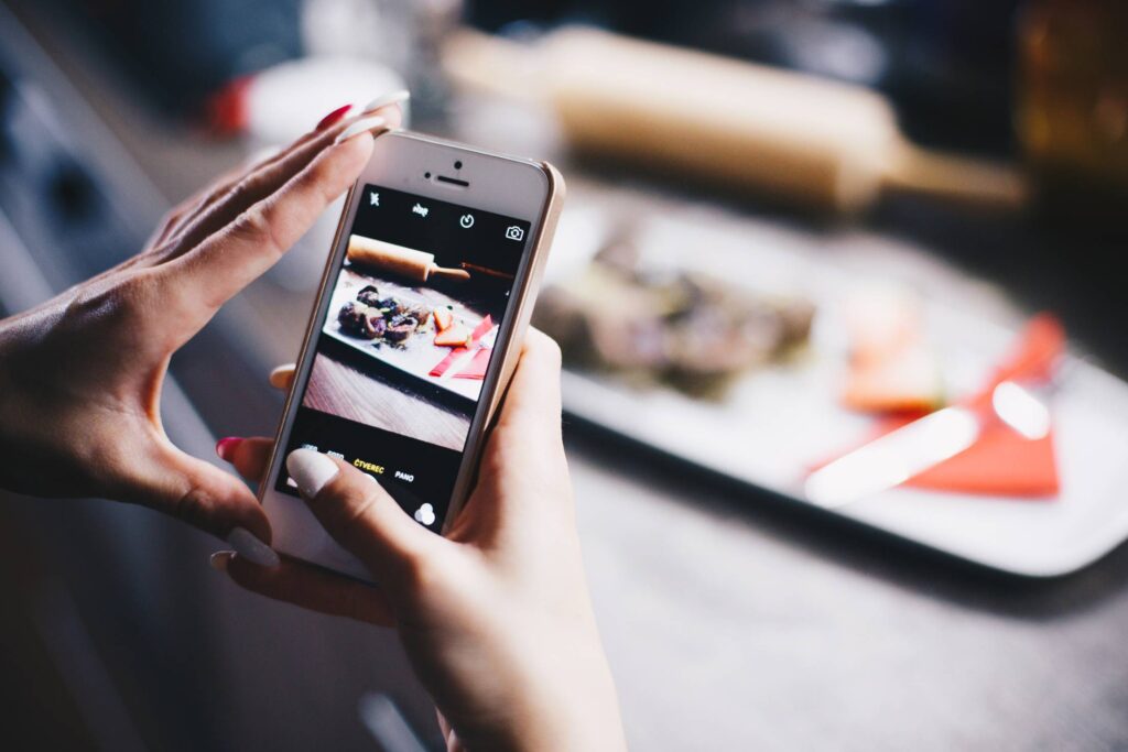 Girl Taking a Photo of Her Food with iPhone Free Photo