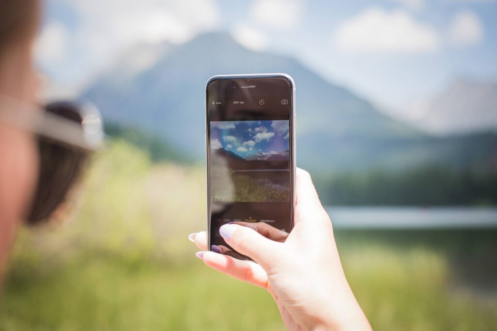 Girl Taking a Photo of Mountains Free Photo