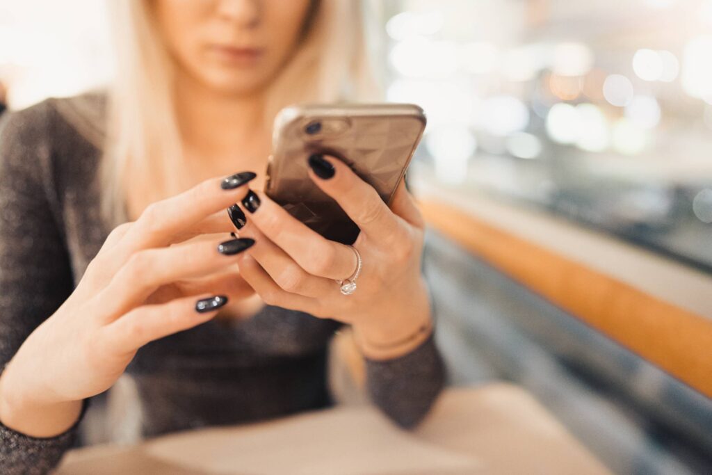 Girl Typing on The Phone Free Photo