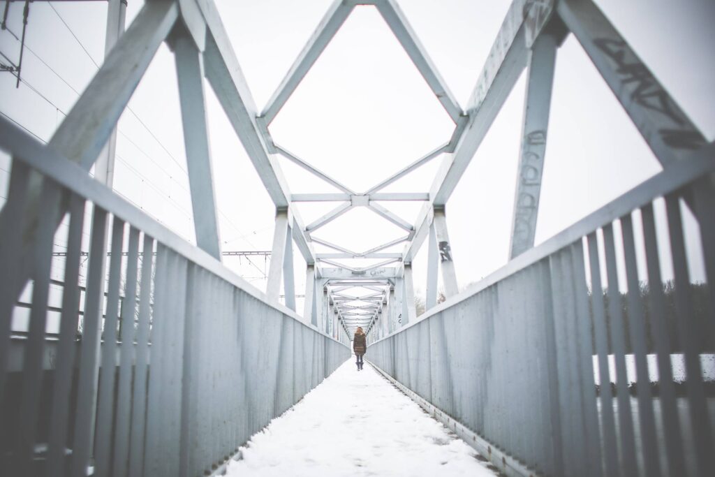 Girl Walking on Steel Bridge in Winter Free Photo